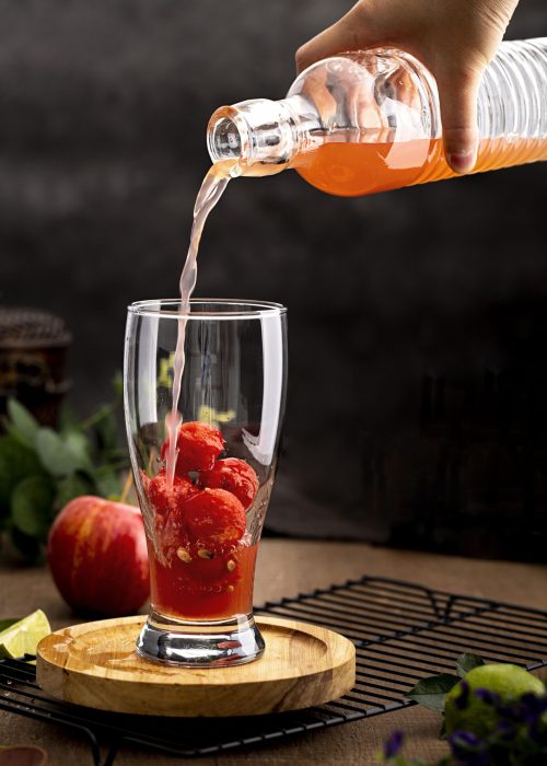 close-up-hand-pouring-tasty-drink